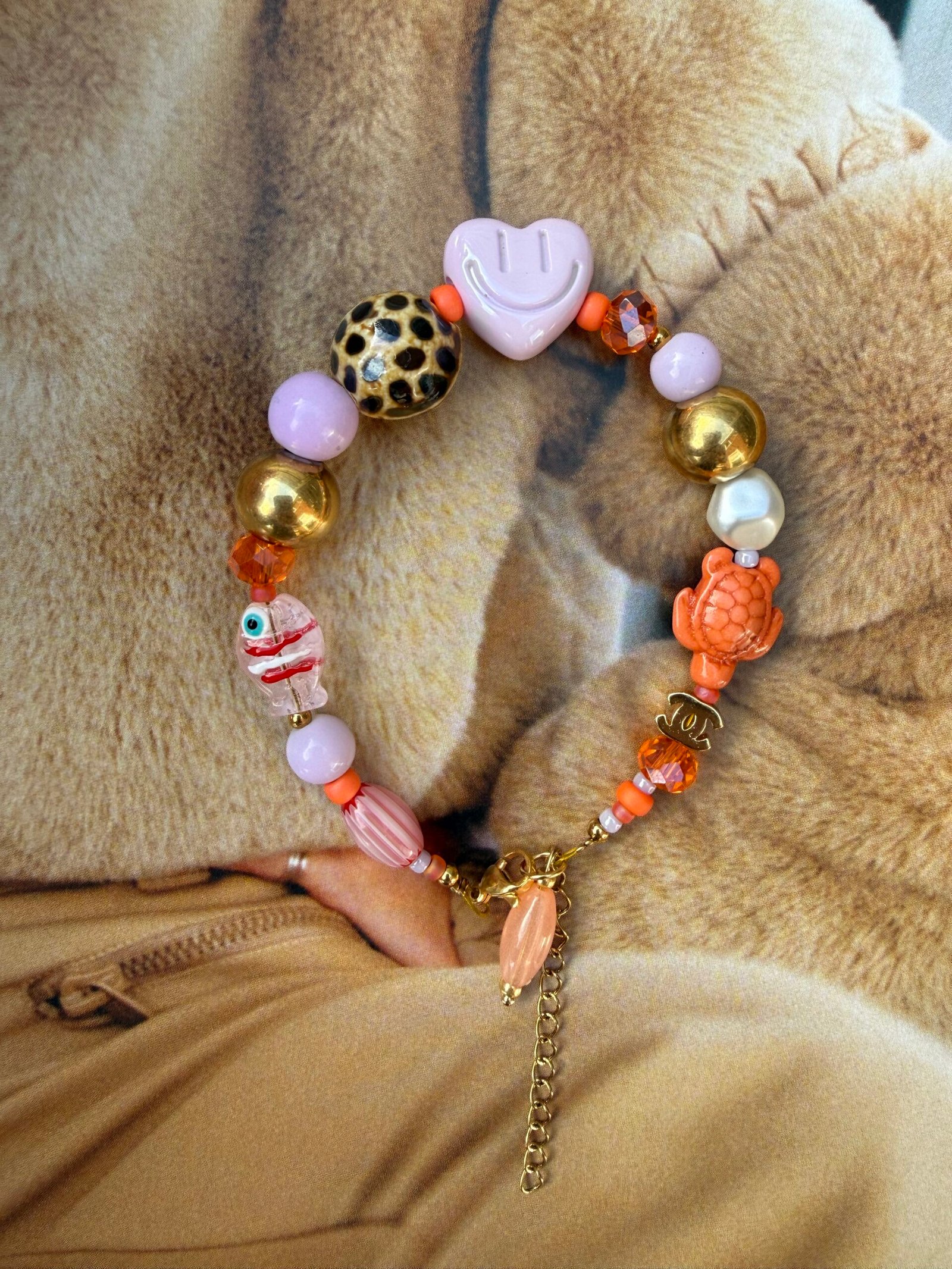 By M armband lila met oranje smiley